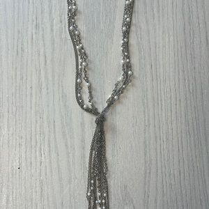 Silver chain, pearl, and bead long necklace with knot and tassel design